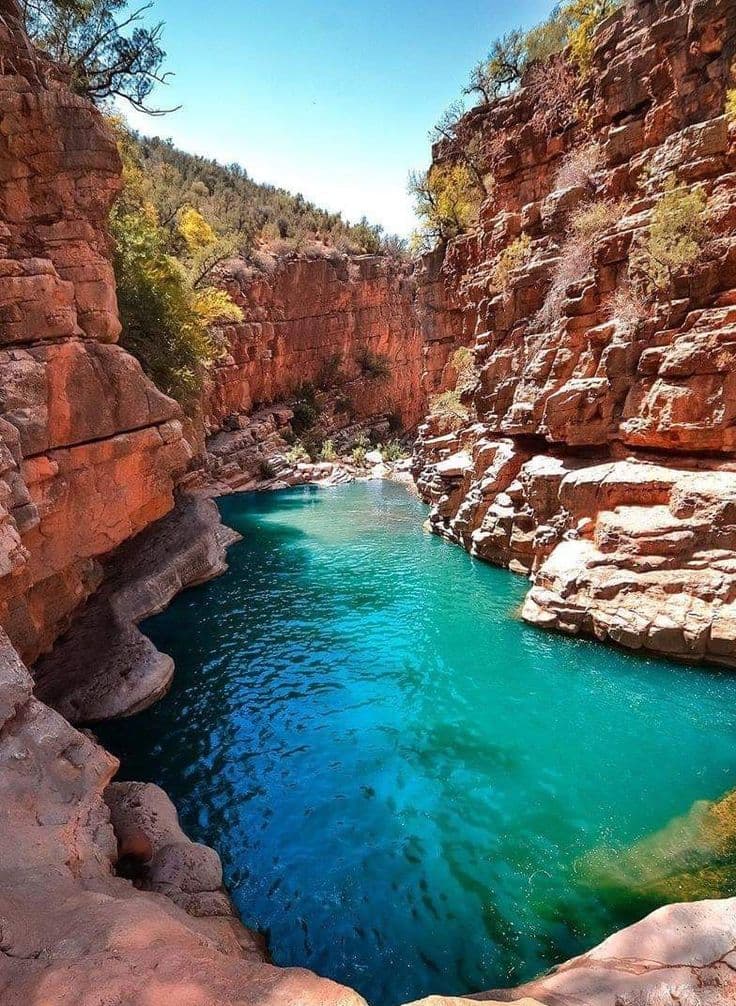 Turquoise plunge pool in a red-rock canyon — Morocco summer swim in cool mountain water